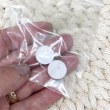 Person holding two refill scent pads for personalised car air freshener.