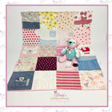 Handmade patchwork memory blanket created from treasured baby clothes, featuring a colourful patchwork design and displayed with a matching memory bear made from the same clothing.
