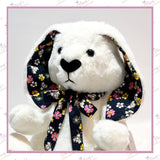 Close-up of the memory rabbit’s shaped face, long floral-lined ears and matching handmade bow.