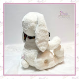 Side profile of the seated memory bunny showing its pear-shaped body, long ears and curved jointed legs.