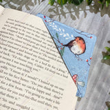 Flat lay of fabric corner bookmark with festive robin bird design.