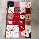 Patchwork memory Christmas sack laid flat showing 24 sections made from outgrown children's clothing