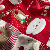 Close-up of baby clothes patchwork Christmas sack showing original Santa and reindeer clothing details