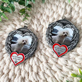 Close-up of two angel wings photo ornaments showing pet remembrance design with red heart that reads You Left Pawprints On My Heart.