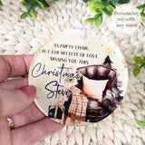 Hand holding the “Empty Chair” acrylic remembrance bauble personalised with Steve, showing the detailed festive chair design and golden tones.