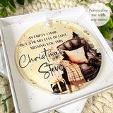 Acrylic memorial bauble in the “Empty Chair” design personalised with Steve, shown inside a white gift box with greenery around the display.