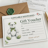 Close-up: “Printed gift voucher with teddy bear illustration beside a kraft envelope with a green wax seal.