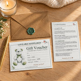 Full set: “Printed gift voucher, matching information card and kraft envelope with a green wax seal displayed on a wooden table.