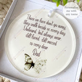 Close-up of personalised acrylic remembrance bauble with green butterfly and white flowers, featuring heartfelt quote about loved ones who have passed – personalised memorial decoration.