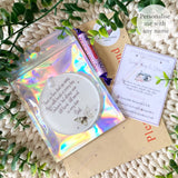 Flat lay of personalised green butterfly remembrance bauble with holographic packaging, thank-you card, and sweet treat – remembrance gift from Loveable Keepsakes UK.