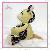 Side view of a handmade Memory Highland Cow Keepsake created from loved one's clothing, showing the fixed arms, fluffy tail and beautifully handcrafted design.