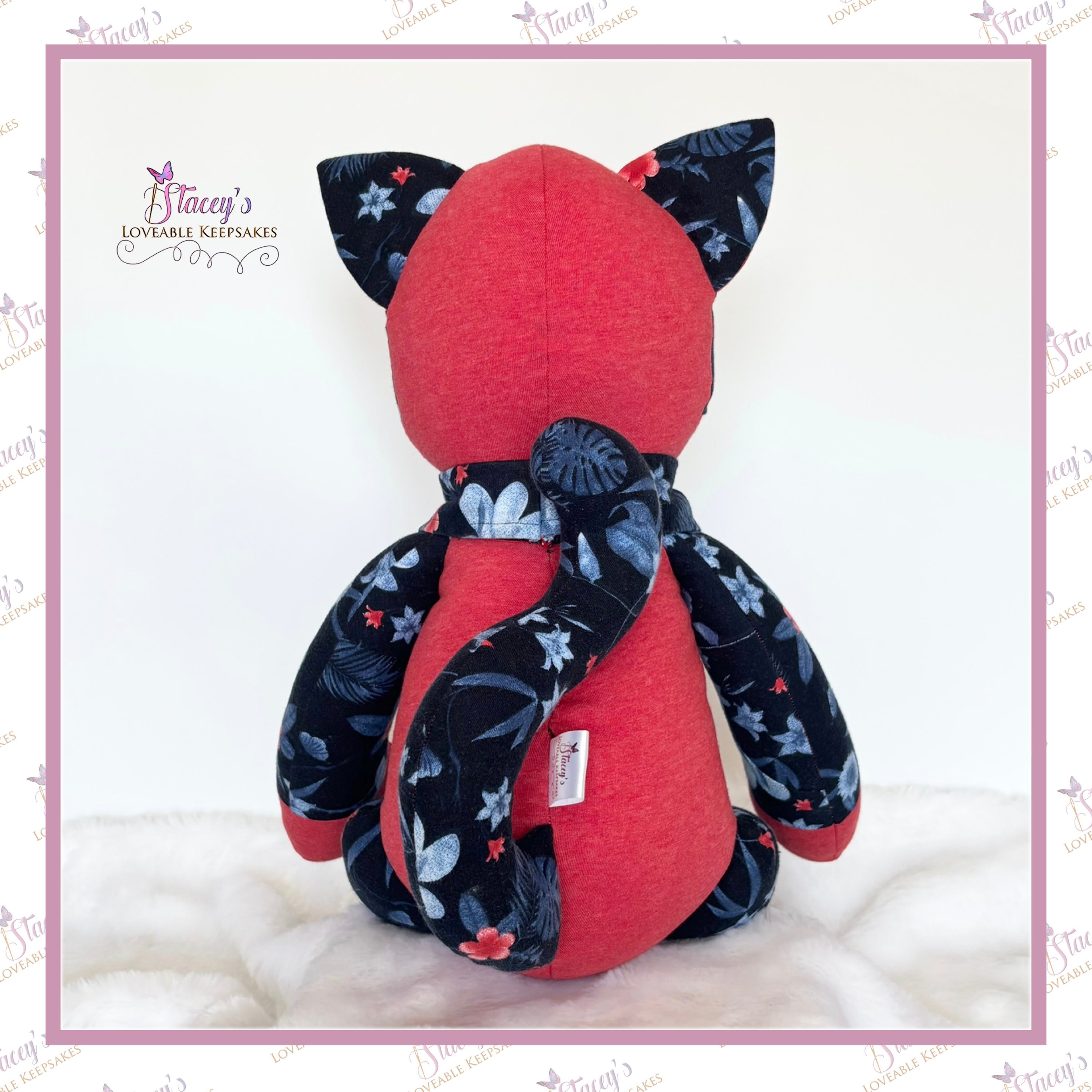 Back view of personalised memory cat keepsake showing long curled tail made from loved one's clothing.