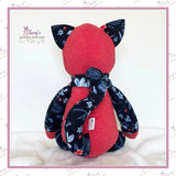Back view of personalised memory cat keepsake showing long curled tail made from loved one's clothing.