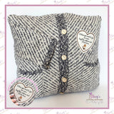 Personalised memory cushion handmade from a loved one's grey knitted cardigan with button fastening and pocket detail, featuring a printed heart patch with robin design and sentimental wording. Custom keepsake cushion made from cherished clothing with optional photo or personalised message.
