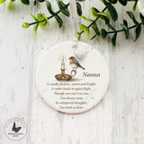 Robin and candle remembrance bauble with angel wings, personalised with the name Nanna on glossy white ceramic.