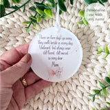 Hand holding a personalised acrylic remembrance bauble with pink butterfly design and the words “Those we love don’t go away…” printed on it – memorial ornament for Mum, personalised with any name.
