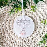 Close-up of personalised acrylic remembrance bauble with pink butterfly and white flowers, featuring heartfelt quote about loved ones who have passed – personalised memorial decoration.