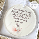 Close-up of personalised acrylic remembrance bauble with pink butterfly and white flowers, featuring heartfelt quote about loved ones who have passed – personalised memorial decoration.