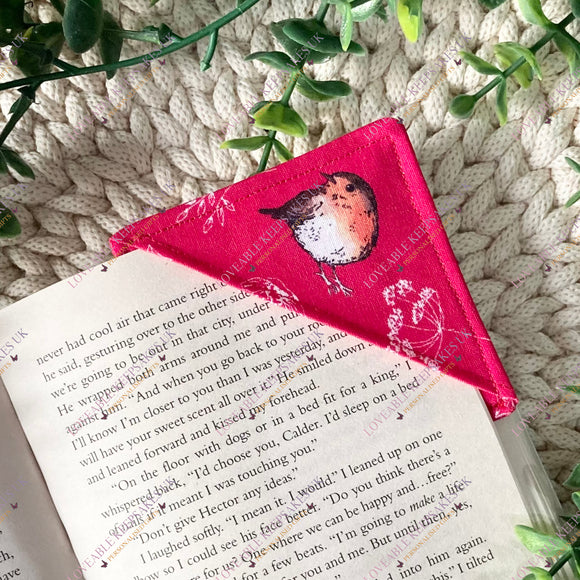 Red fabric bookmark with a robin bird design on a book