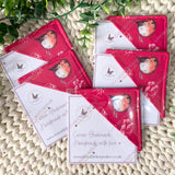 Red  bookmarks with robin bird design on a textured surface