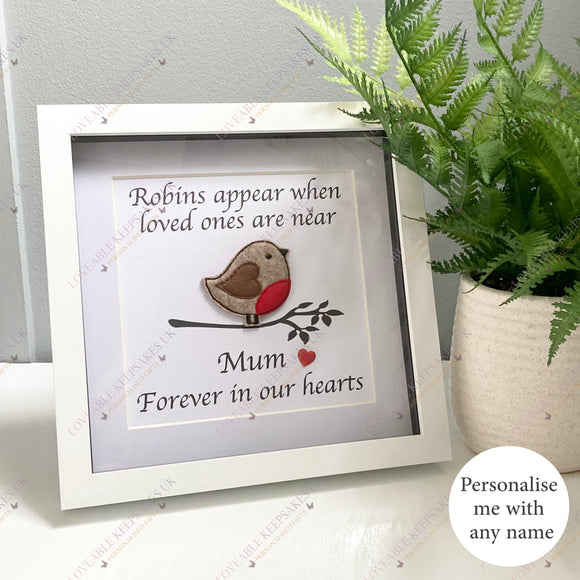 Image of a personalised robin memorial box frame with embroidered felt robin, printed message “Robins appear when loved ones are near,” and custom name on luxury white card. Framed in a white square shadow box.