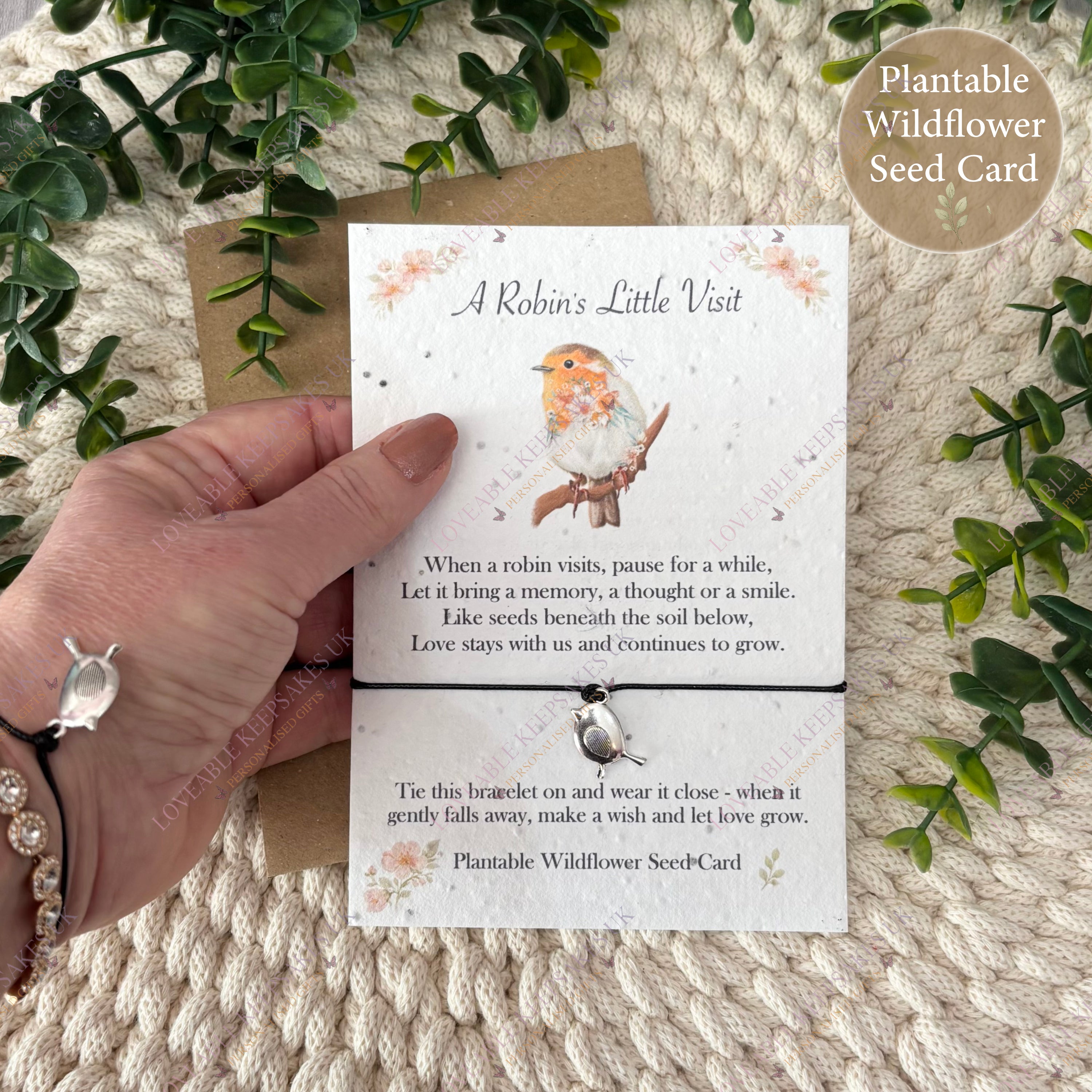 Hand holding robin wish bracelet card showing plantable wildflower seed paper