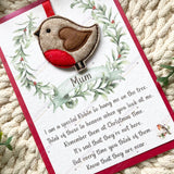 Close-up of a felt robin Christmas tree ornament mounted on a personalised remembrance poem card reading “Mum.