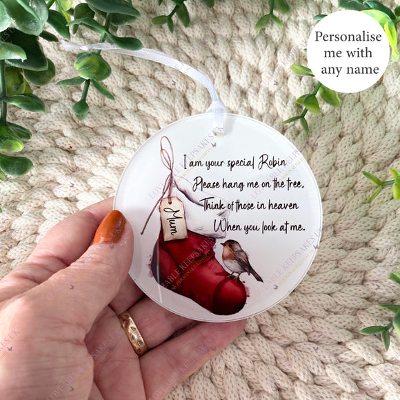 Hand holding a personalised robin remembrance Christmas stocking bauble with “Mum” on the tag