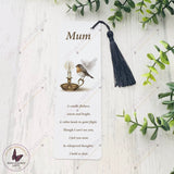 Bookmark with a robin and candle illustration on a white background with greenery.