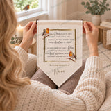 Personalised robin memorial pennant with remembrance verse and In loving memory of Nanna, shown being held.