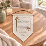 Personalised robin remembrance pennant with In loving memory of Mum, displayed flat on a wooden table.