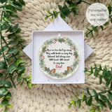Acrylic robin remembrance wreath bauble personalised with Dad, displayed in white gift box on soft knitted background.