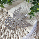 Close-up of guardian angel bookmark on a open book.