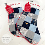 Two personalised patchwork memory stockings handmade from clothing, each with embroidered name and poem tag, keepsake design for Christmas remembrance.
