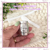 Small and discreet silver memorial urn measuring approximately 4 cm tall and 3 cm wide with spoon and bag