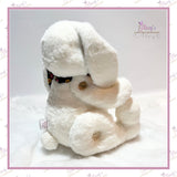     Rear three-quarter view of the memory bunny showing wooden “Handmade With Love” buttons and fluffy tail.