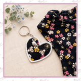 Personalised memory heart keyring displayed beside the loved one’s floral clothing used to make it.