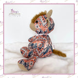 Side view of Small Memory Highland Cow keepsake handmade from loved one's patterned clothing, showing the fluffy fur tail