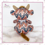 Back view of Small Memory Highland Cow keepsake handmade from loved one's patterned clothing, showing the fur tail